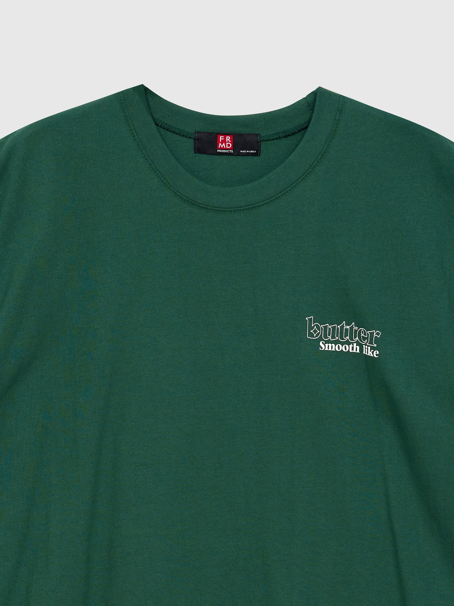 A close-up view of the t-shirt highlighting the smooth like butter graphic design detail.