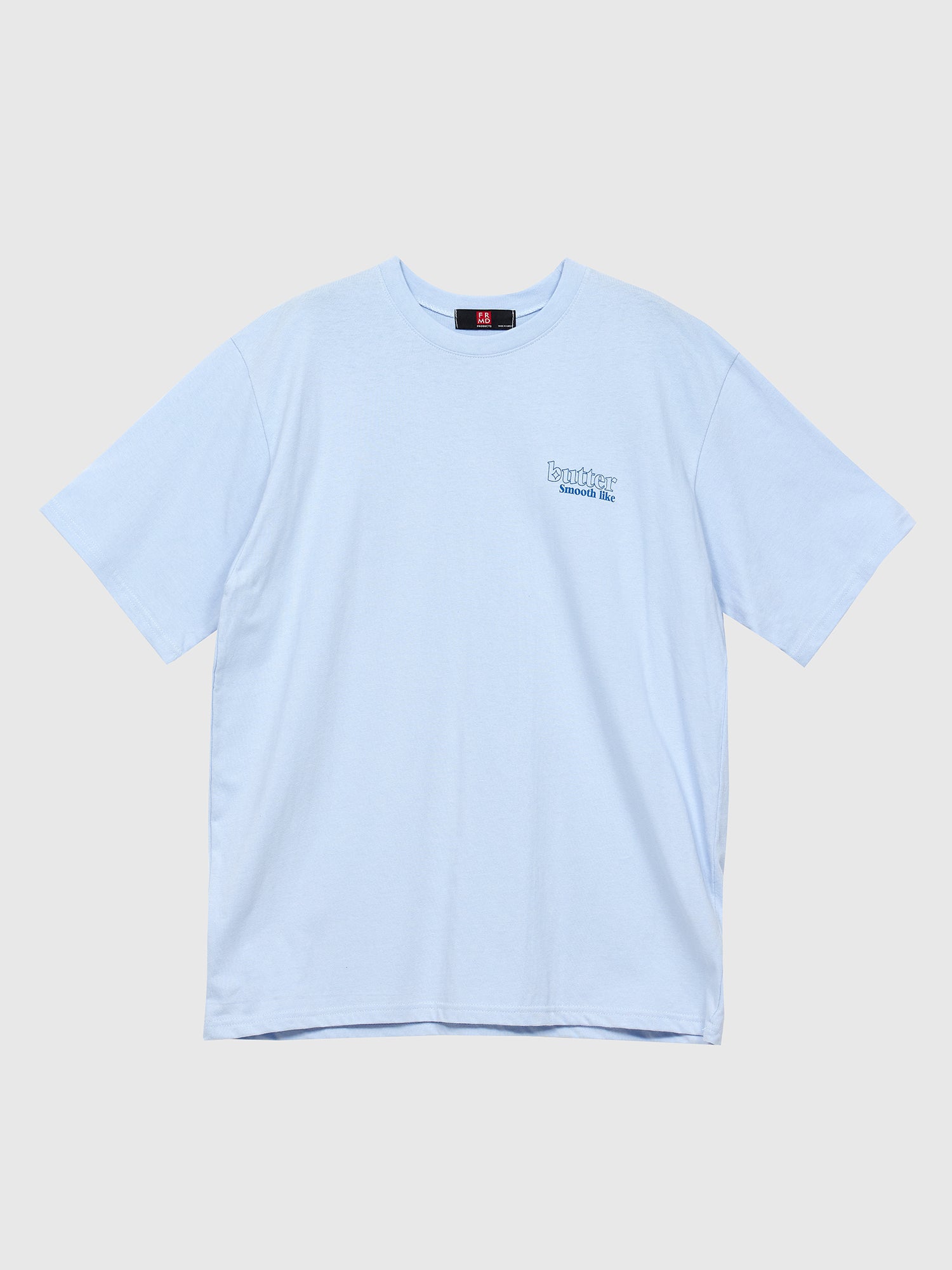 A front view of the Korean street fashion inspired light blue 'Smooth Like Butter' T-shirt against a gray backdrop, showcasing its trendy appeal and effortless style.