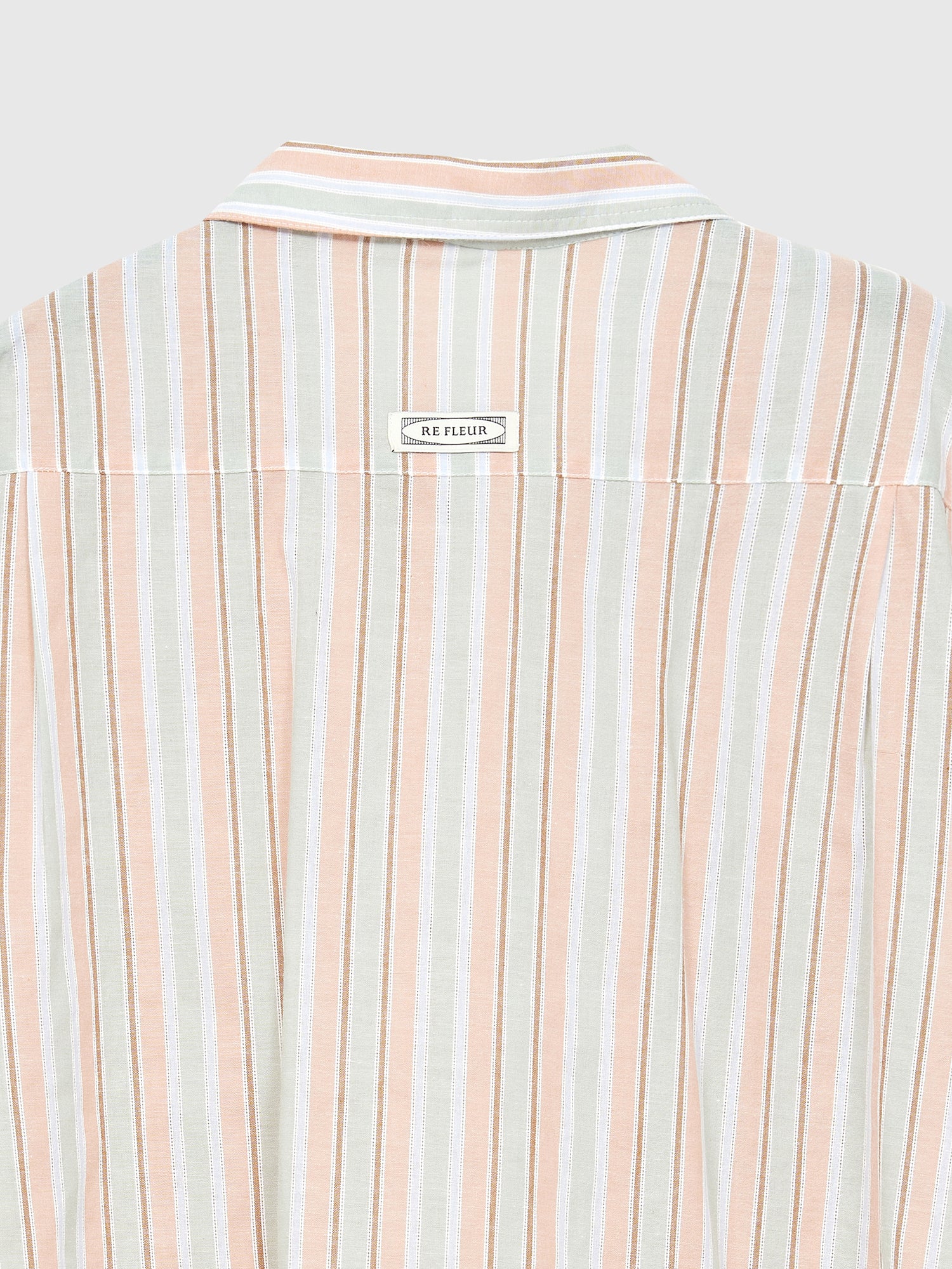 Back close-up view of the stripe print shirt showing the seam stitching details and the fabric textures.