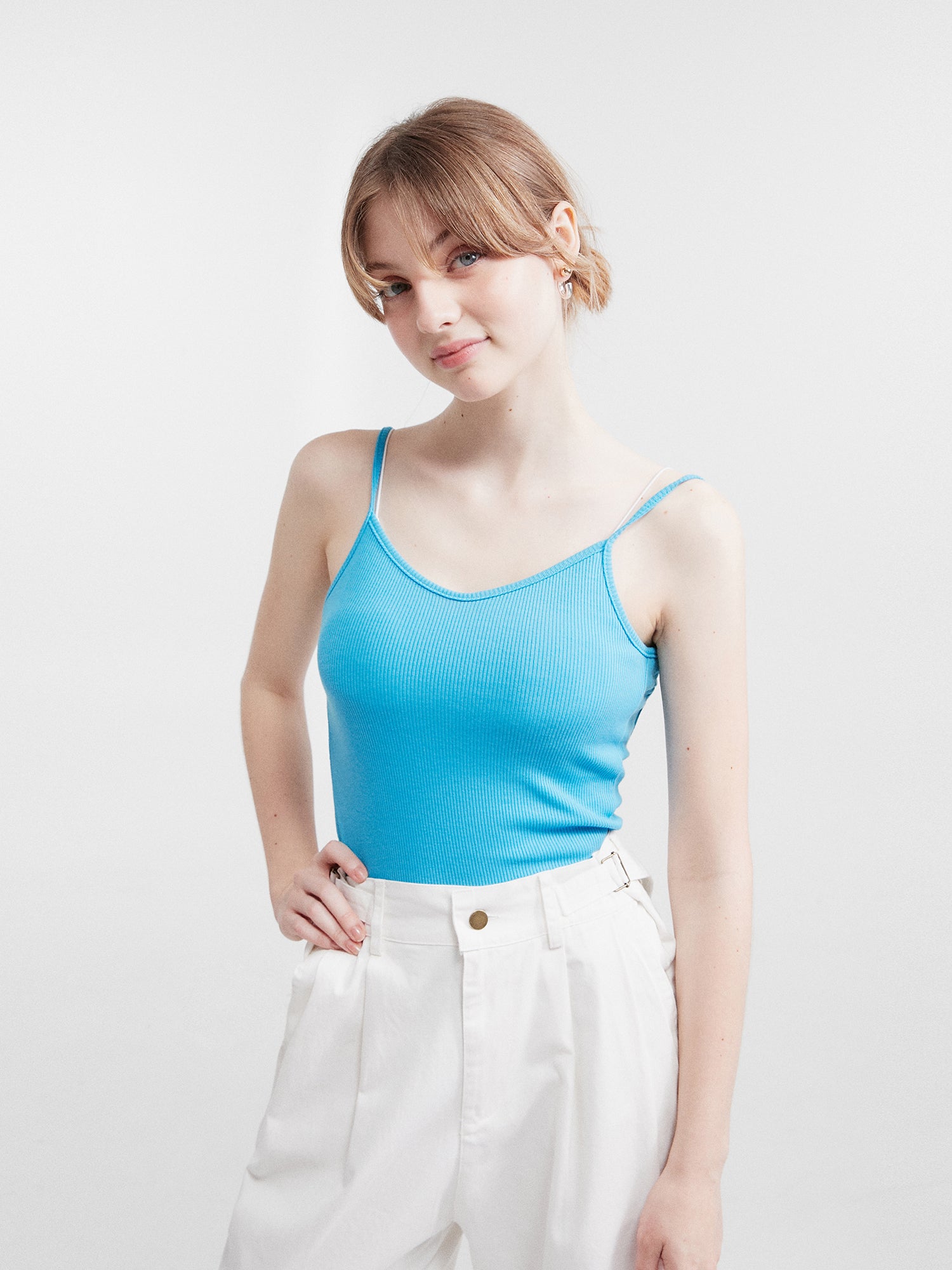 A stunning model in Korean street fashion dons the blue tank top in a captivating shot, exuding style and confidence.