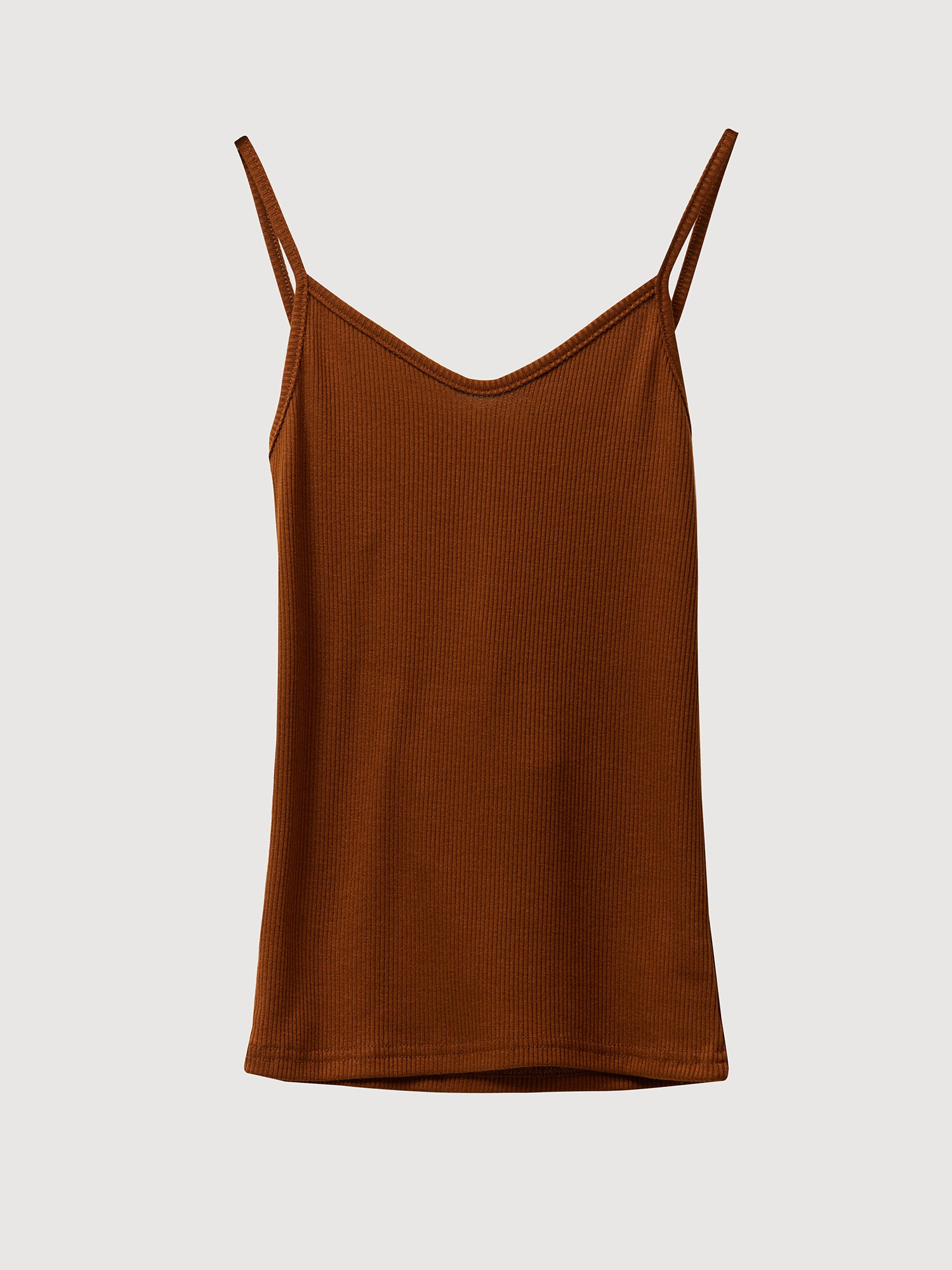 Product detailed shot of a tank top in Korean street fashion, beautifully displayed against a white backdrop, highlighting its design and versatility.