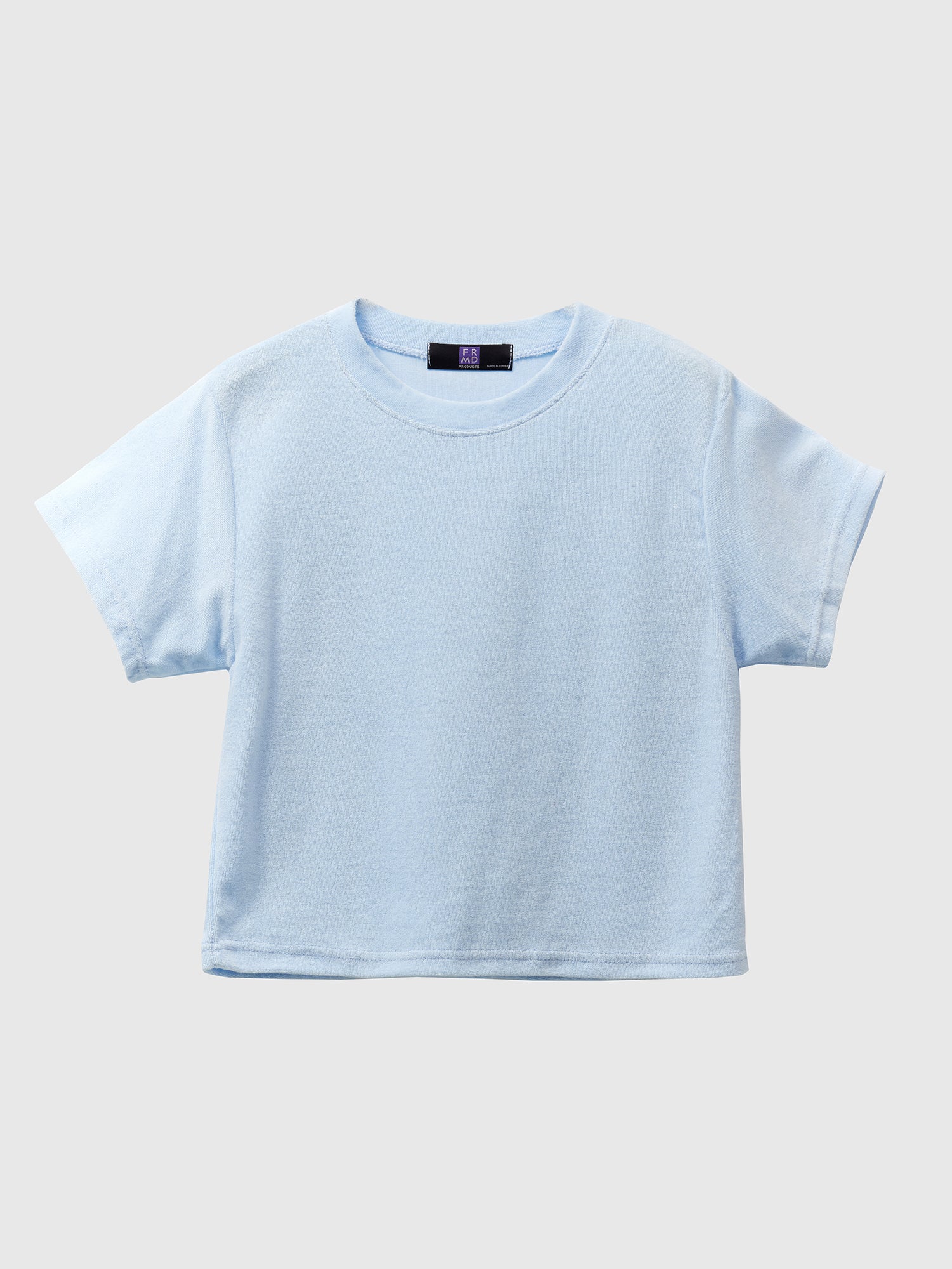 Product detailed shot of a light blue crewneck top, exemplifying Korean street fashion, elegantly presented against a white backdrop.