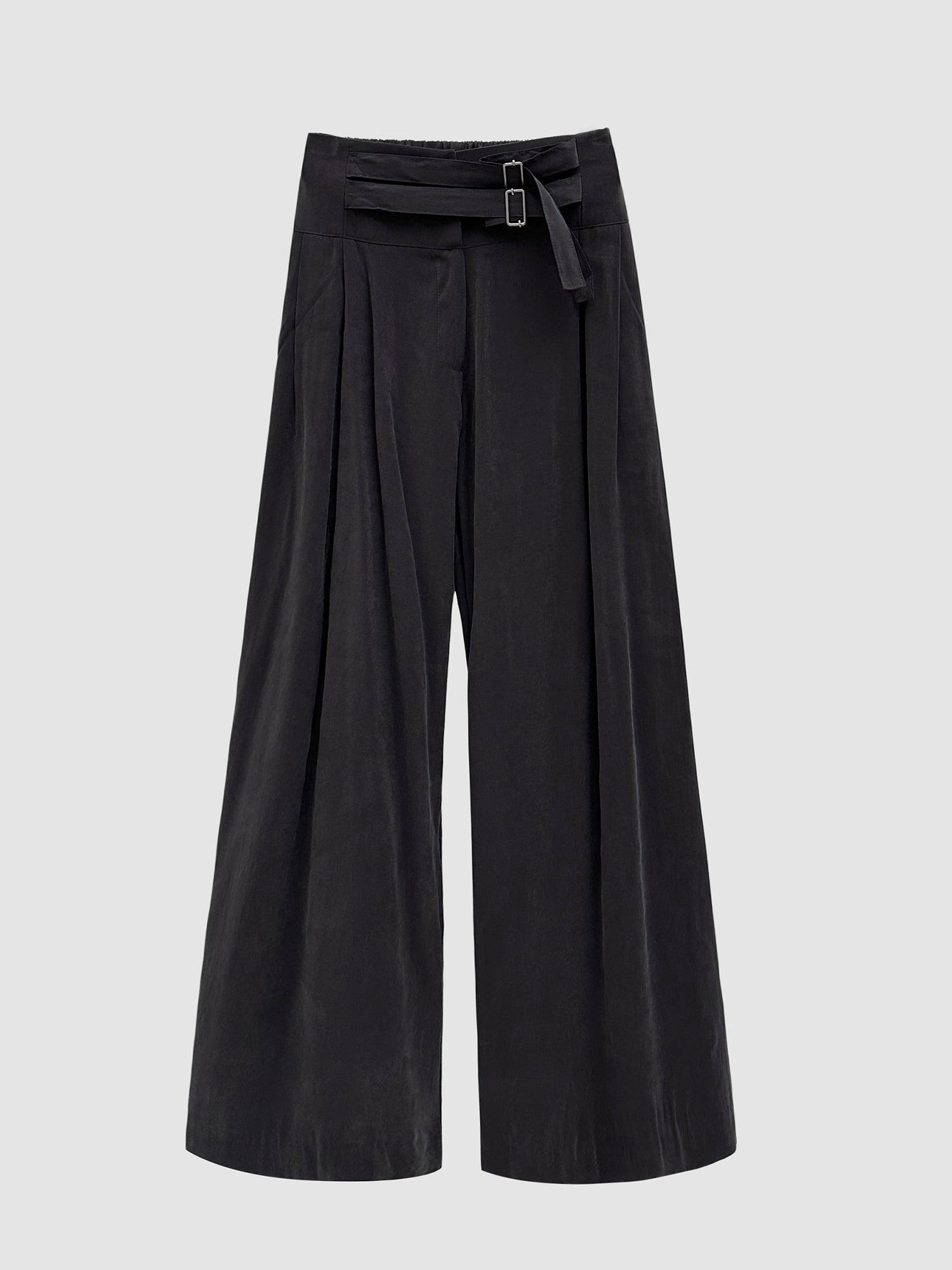 A front-facing, detailed view of the black Two Belted Suede Trouser set against a gray backdrop, accentuating the intricate design features on the trouser's front.