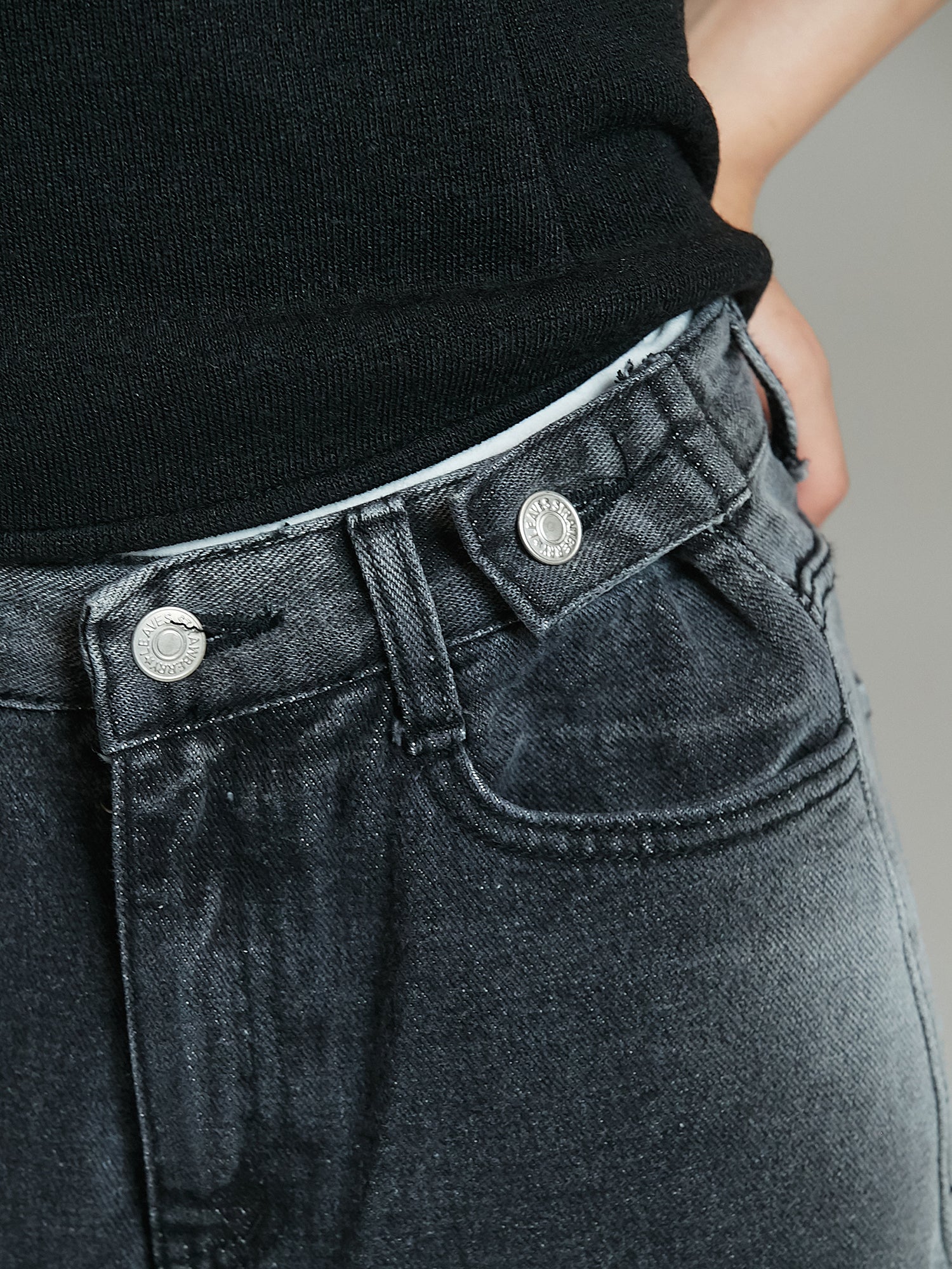 Take a close-up shot of the Washed Rip Jeans, revealing the intricate belt detail.