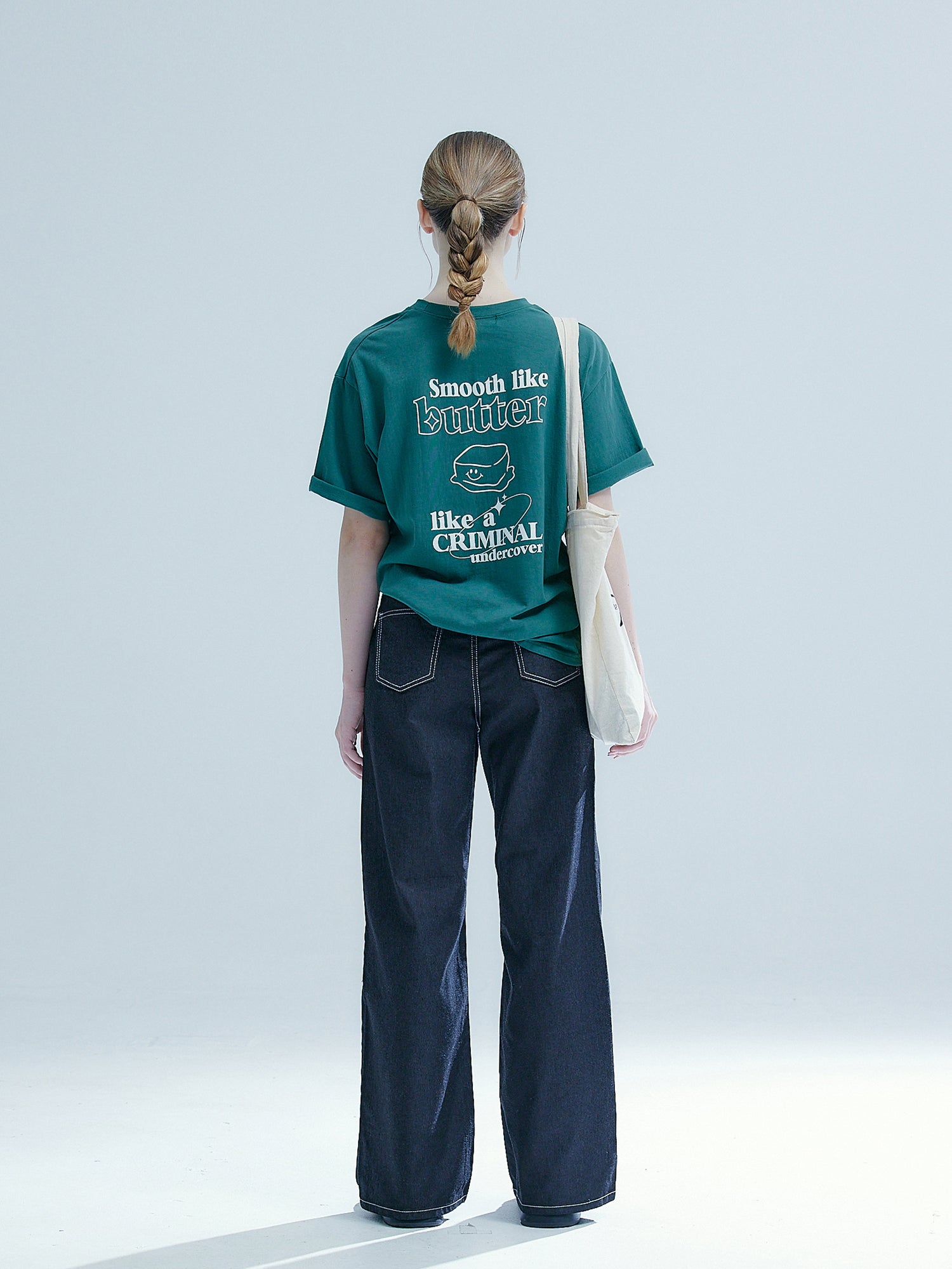 Back view of the model wearing the wide leg denim jeans showing the back design of the denim jeans.