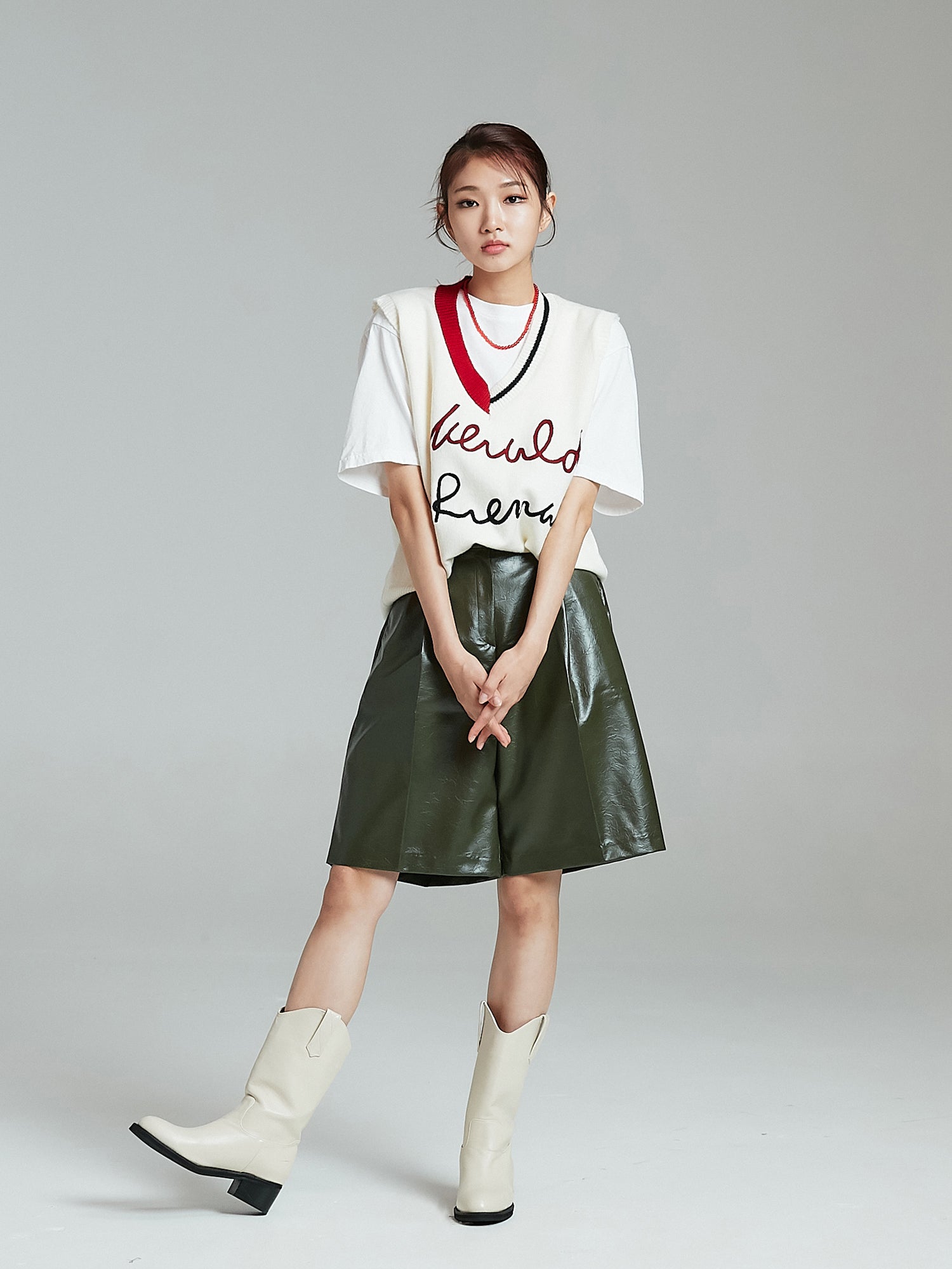 Model is posing wearing the wide leather shorts paired showcasing the korean street fashion vibe.