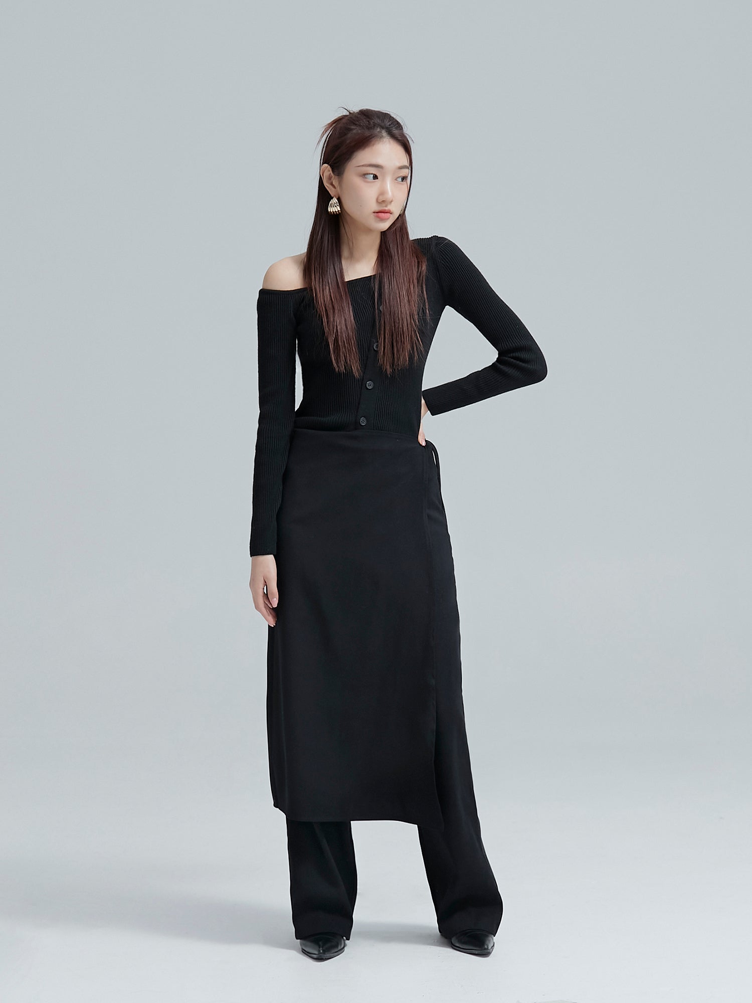 The model is posing while wearing the wrap skirt pants to accentuate its unique south korea fashion.