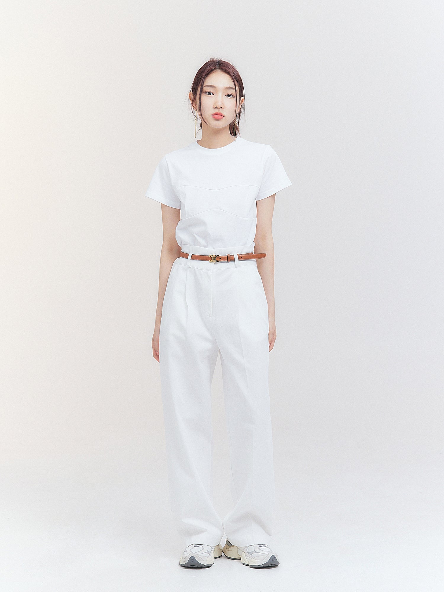 Front view of the model wearing the white belted pleated trouser showing the korean aesthetic outfits.