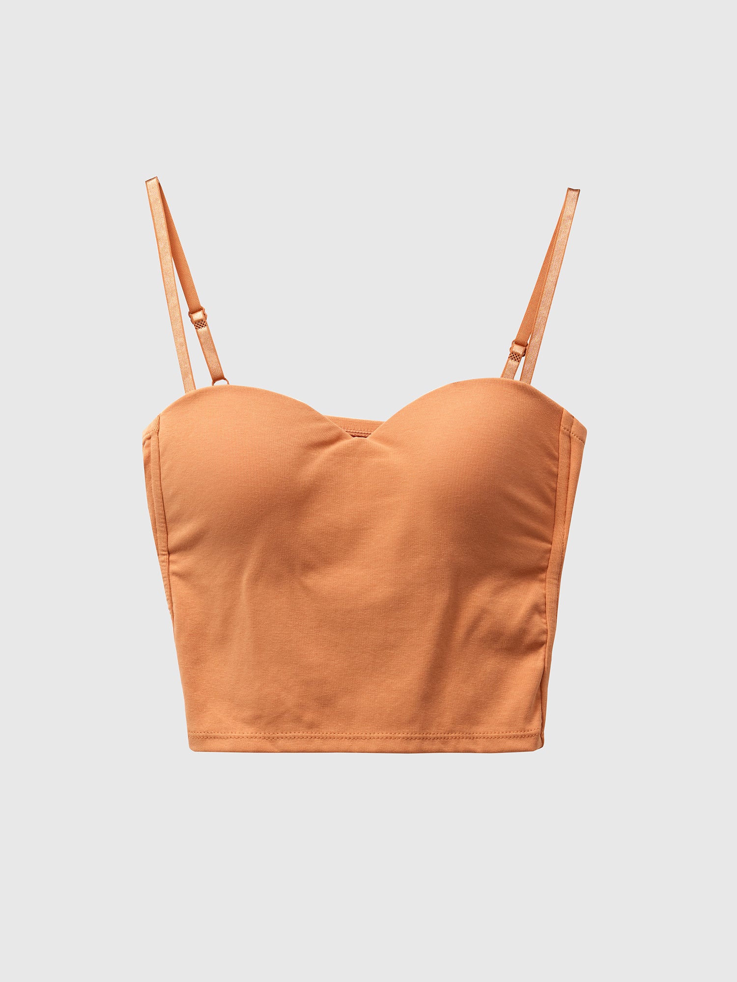 Product detailed shot of the orange bustier crop top with white backdrop.