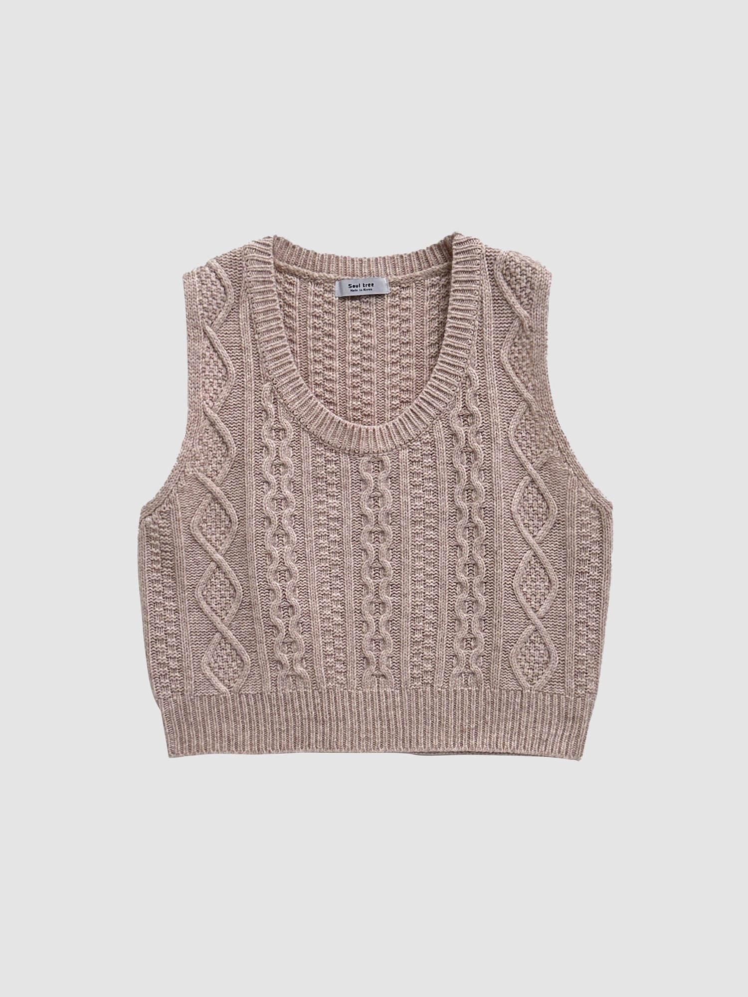 Product detailed shot of the mauve cable knit vest showing the front detailed designs.