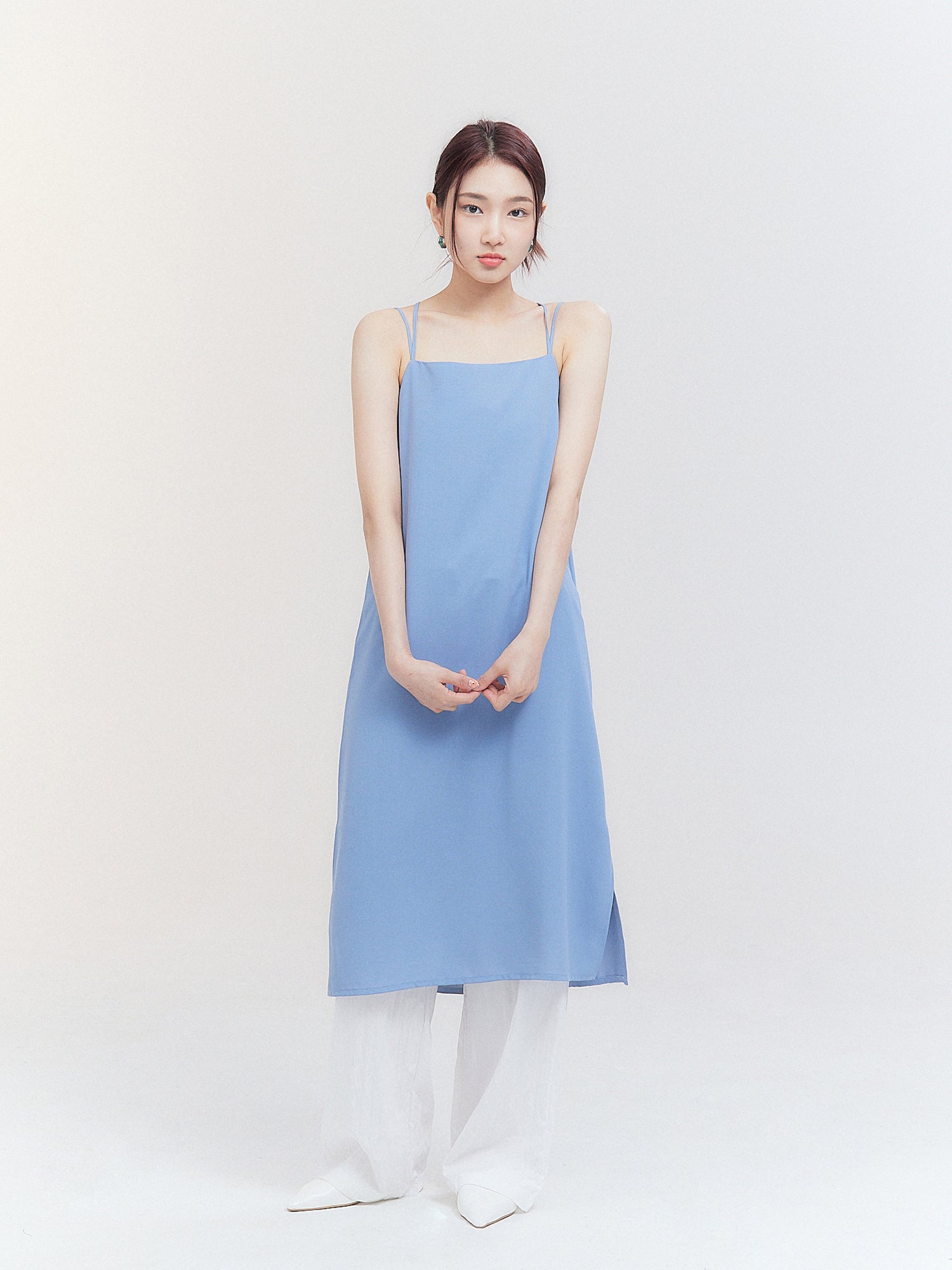 Front view of the model wearing the light blue cami dress showing the full-length of the dress.