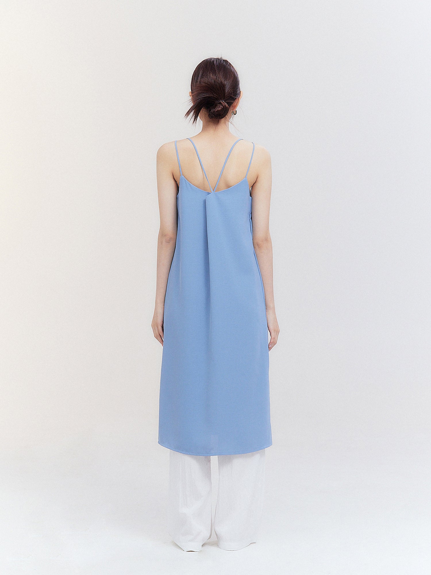 Highlight the elegance of South Korean fashion with a back view of the light blue cami dress, showcasing the intricate design on the back of the garment.