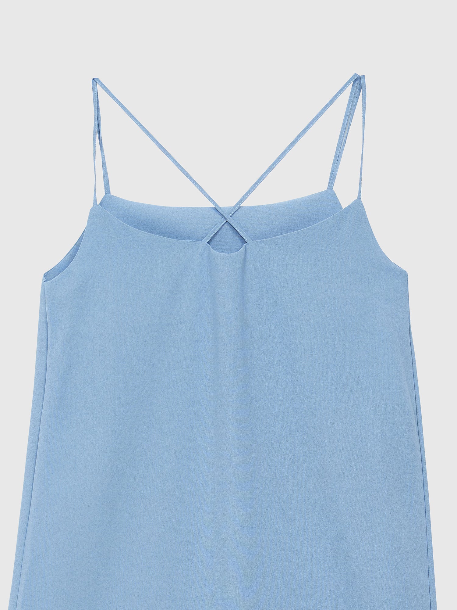 A closer look at the back of our light blue cami dress, highlighting its captivating cross-sectional detail.