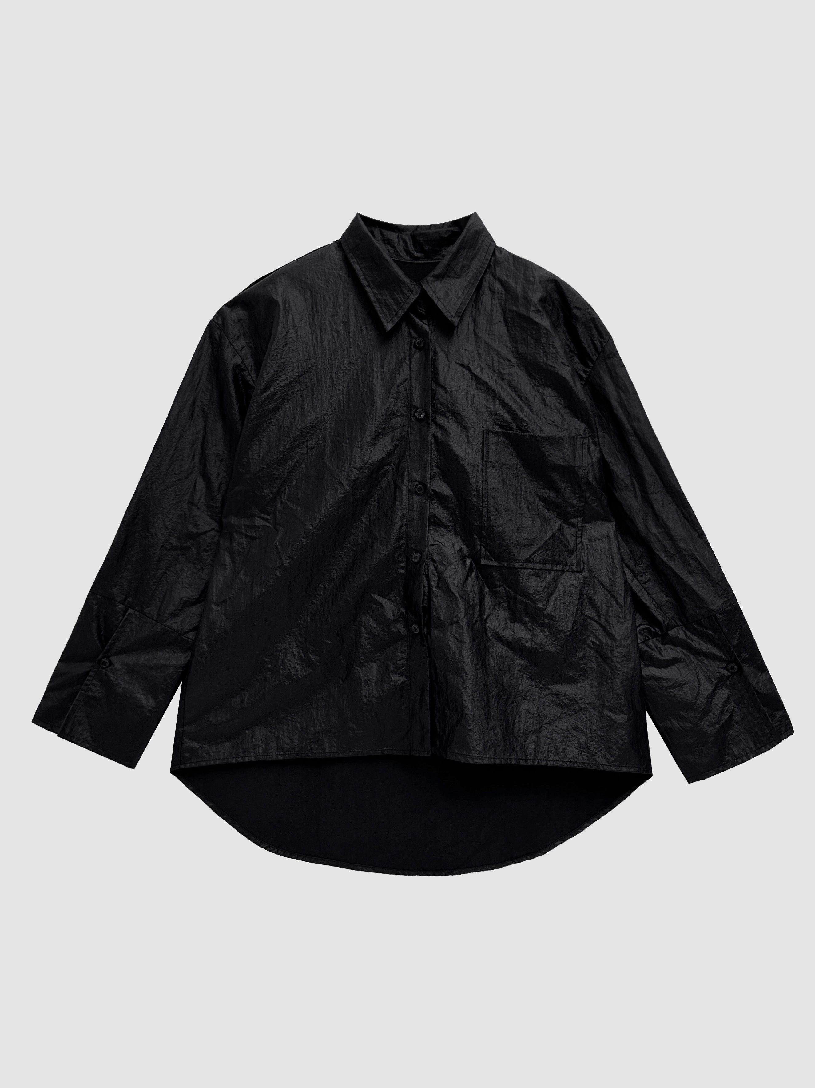 Product detailed view of the black coated shirt with pockets with white background.