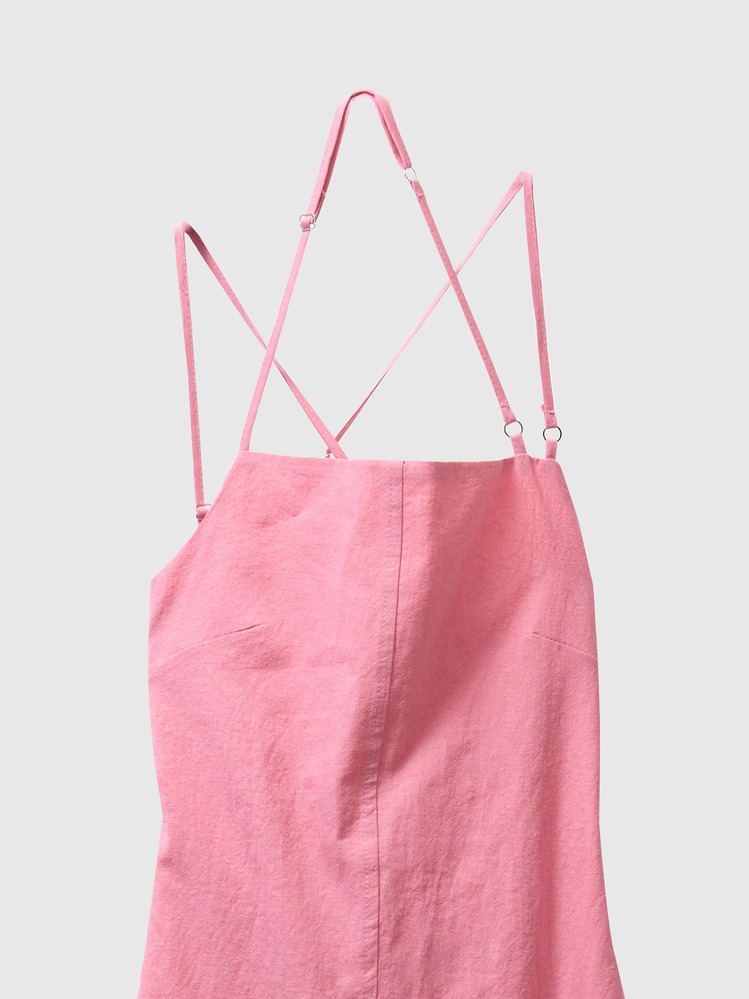 A close-up view of the pink backless midi dress.