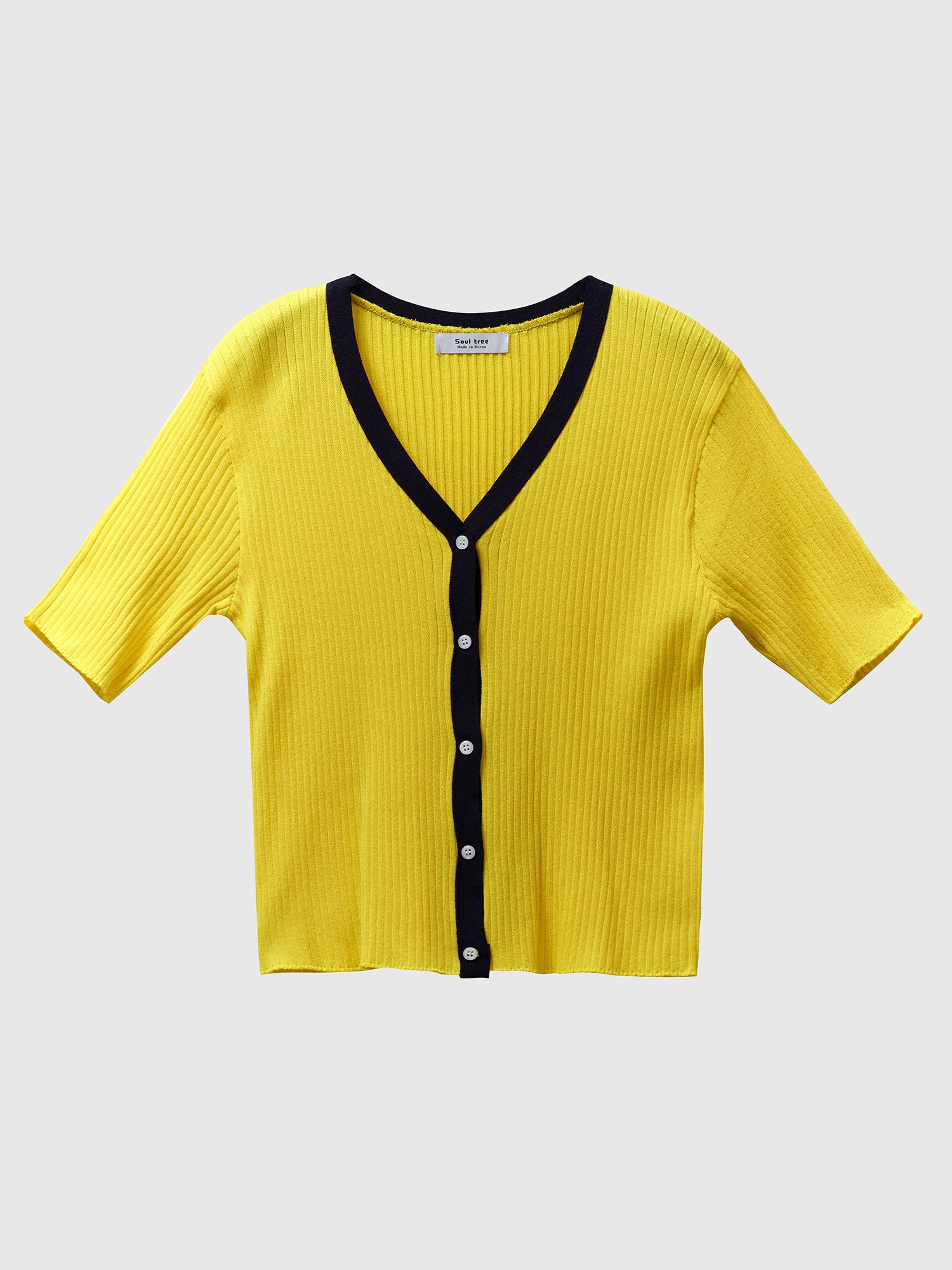 Product detailed shot showcasing contemporary fashion, featuring a yellow contrasting trim cardigan against a clean white backdrop, emphasizing the modern and stylish appeal of the garment.