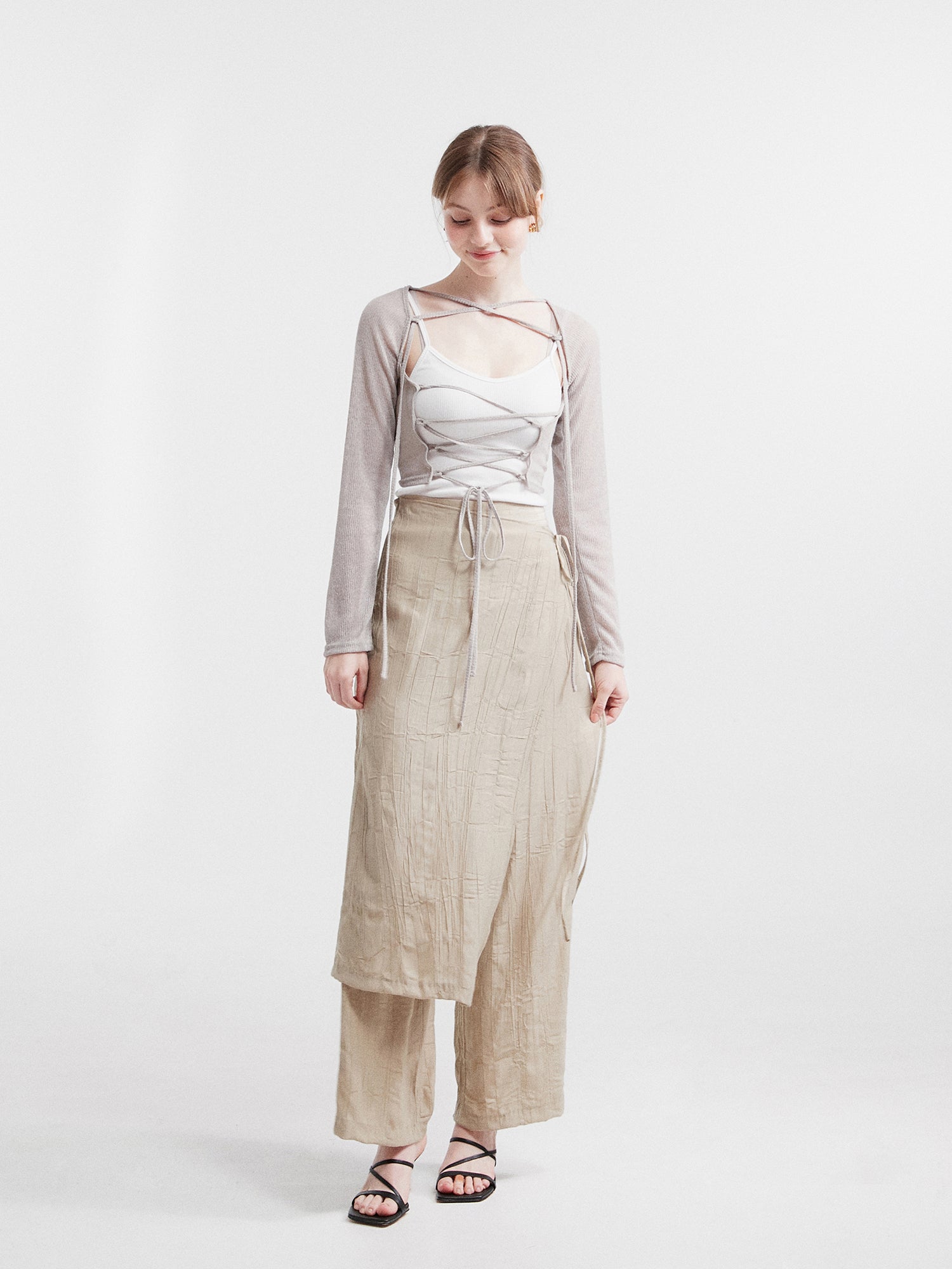 A captivating full-shot capturing contemporary fashion, featuring the model confidently wearing the layered skirted pants, exemplifying a modern and stylish approach to dressing.