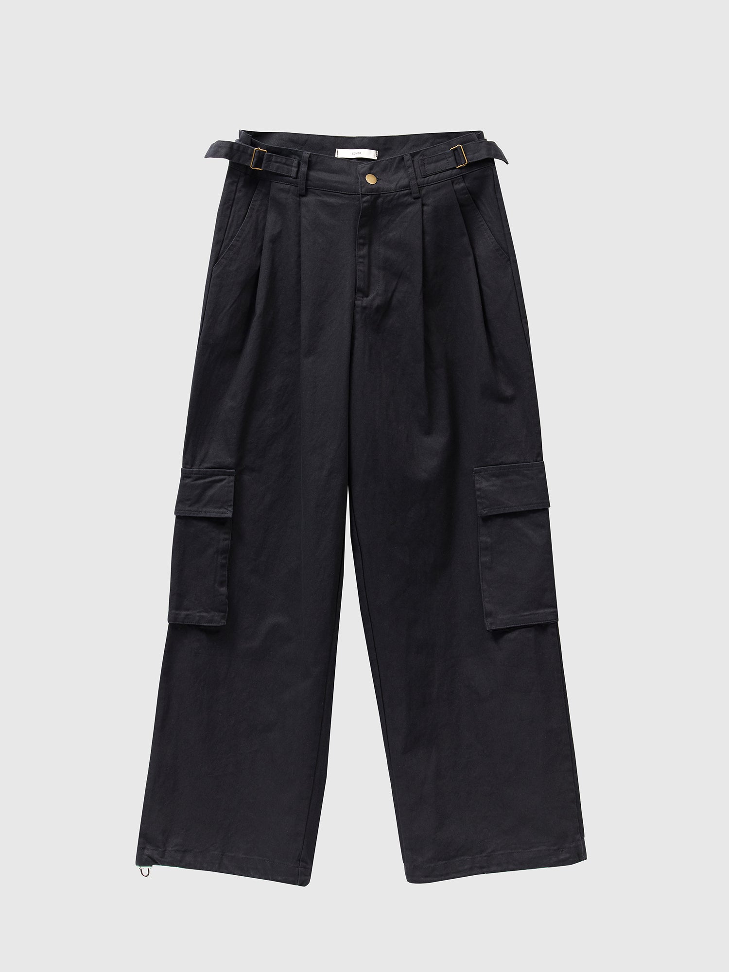 Product detailed shot of Korean street fashion, showcasing black cargo pants against a minimalist white backdrop, epitomizing the edgy and trendy aesthetic.