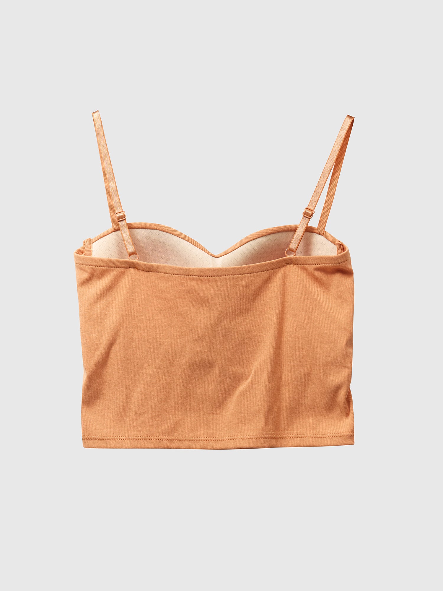 Product detailed shot of the orange bustier crop top showcasing the back detail of the top.