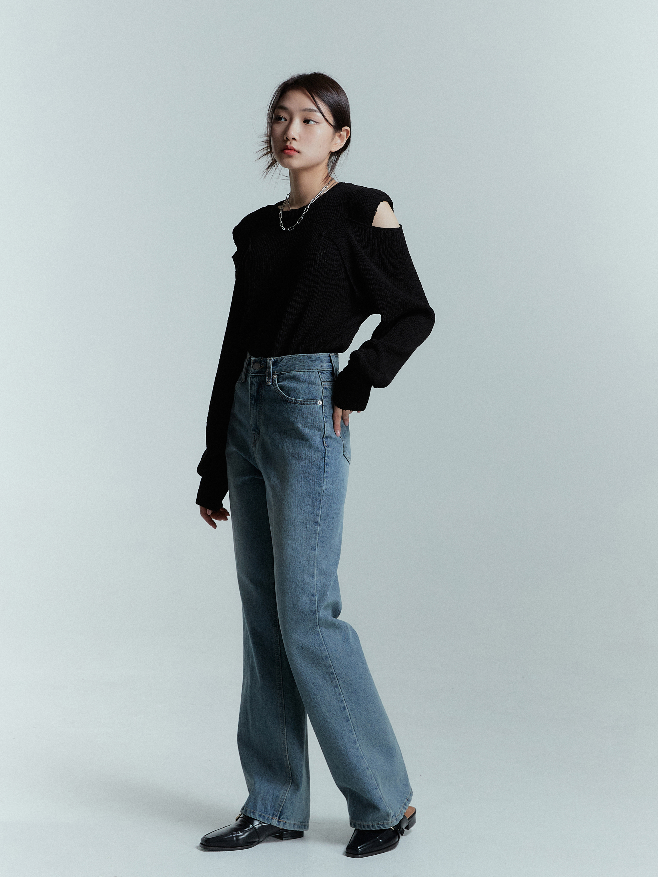 A captivating side angle as a model wears the wide leg jeans, revealing a unique and stylish side profile of the denim.