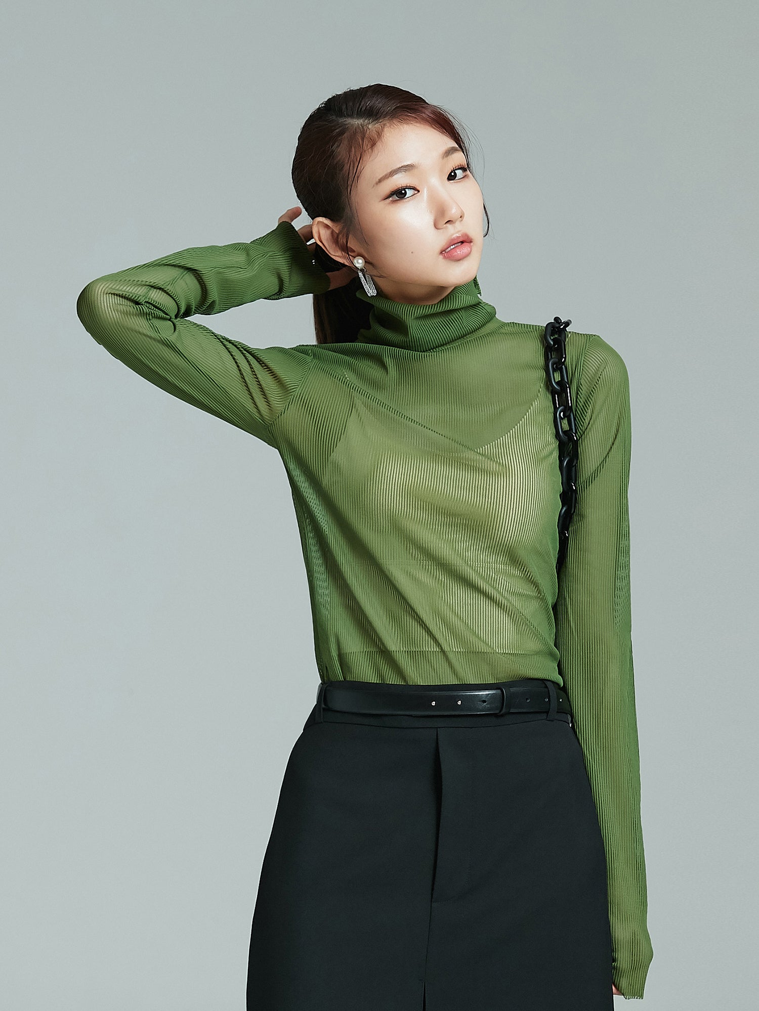 Tilted angle of the model wearing the mesh turtleneck showcasing the korean street style look.