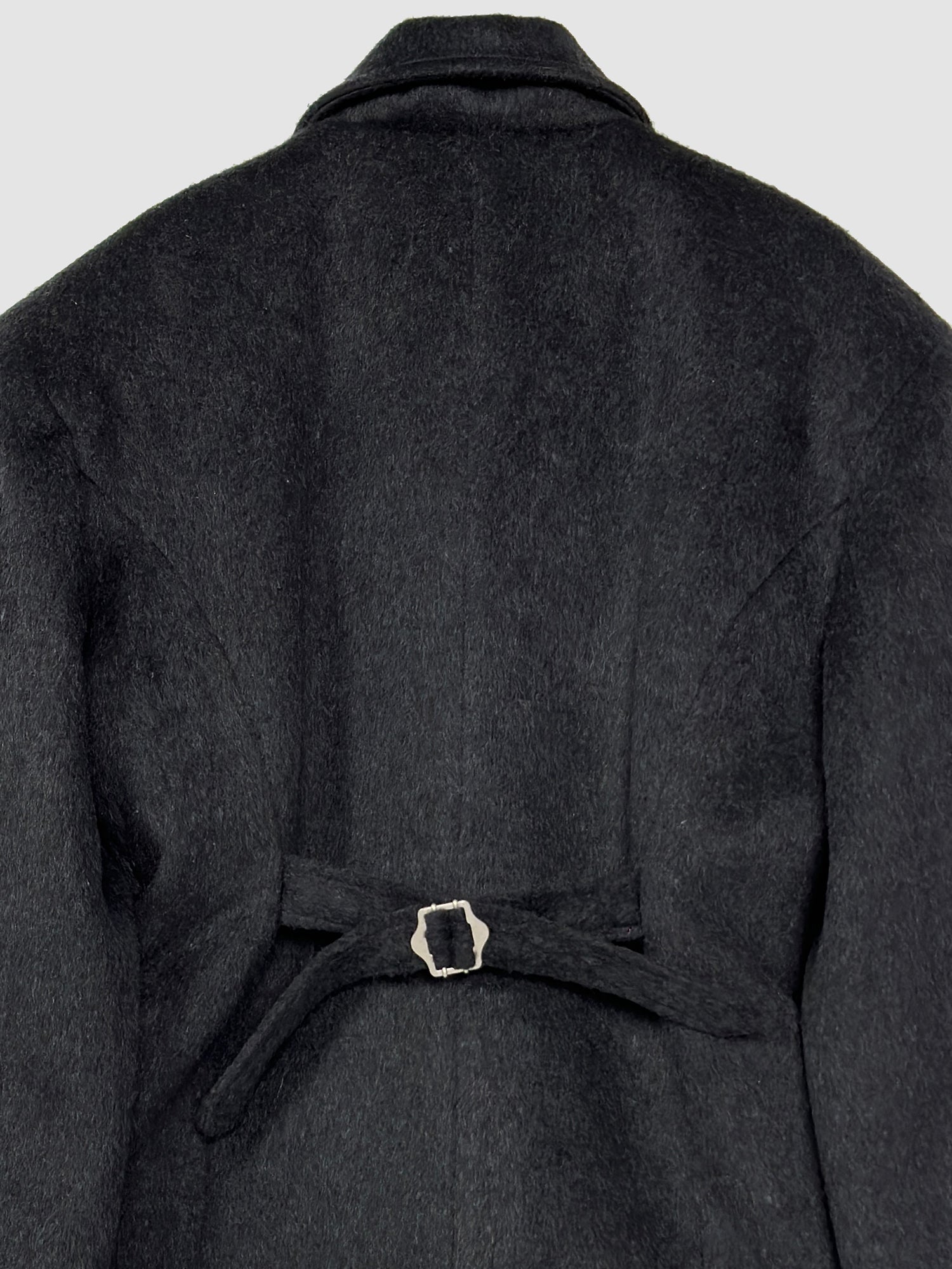 A close-up perspective of the back side of the padded fitted coat, highlighting the intricate design detail of its adjustable belt.