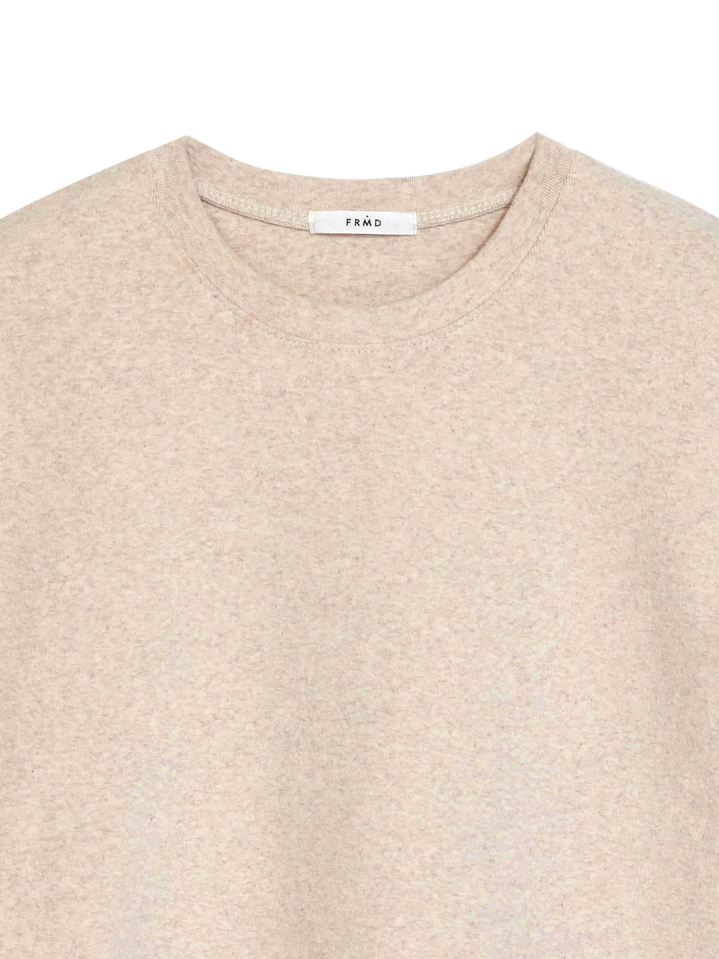 Close-up of the basic crewneck t-shirt that shows the detail of the ribbed crewneck and the fabric.