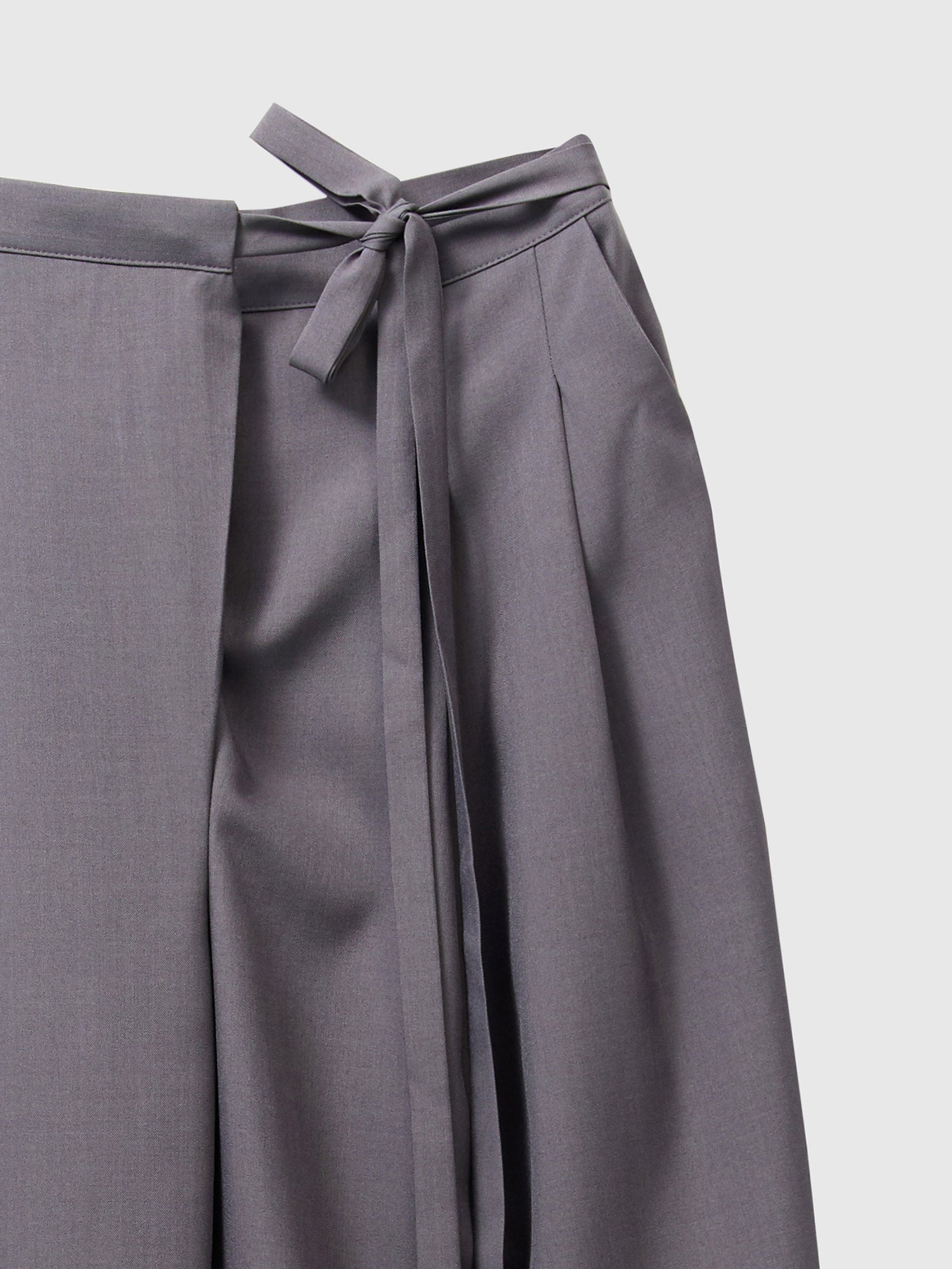 Zoomed-in shot of the side-belted trouser, showcasing the intricate design of the side-belt and seam stitching.