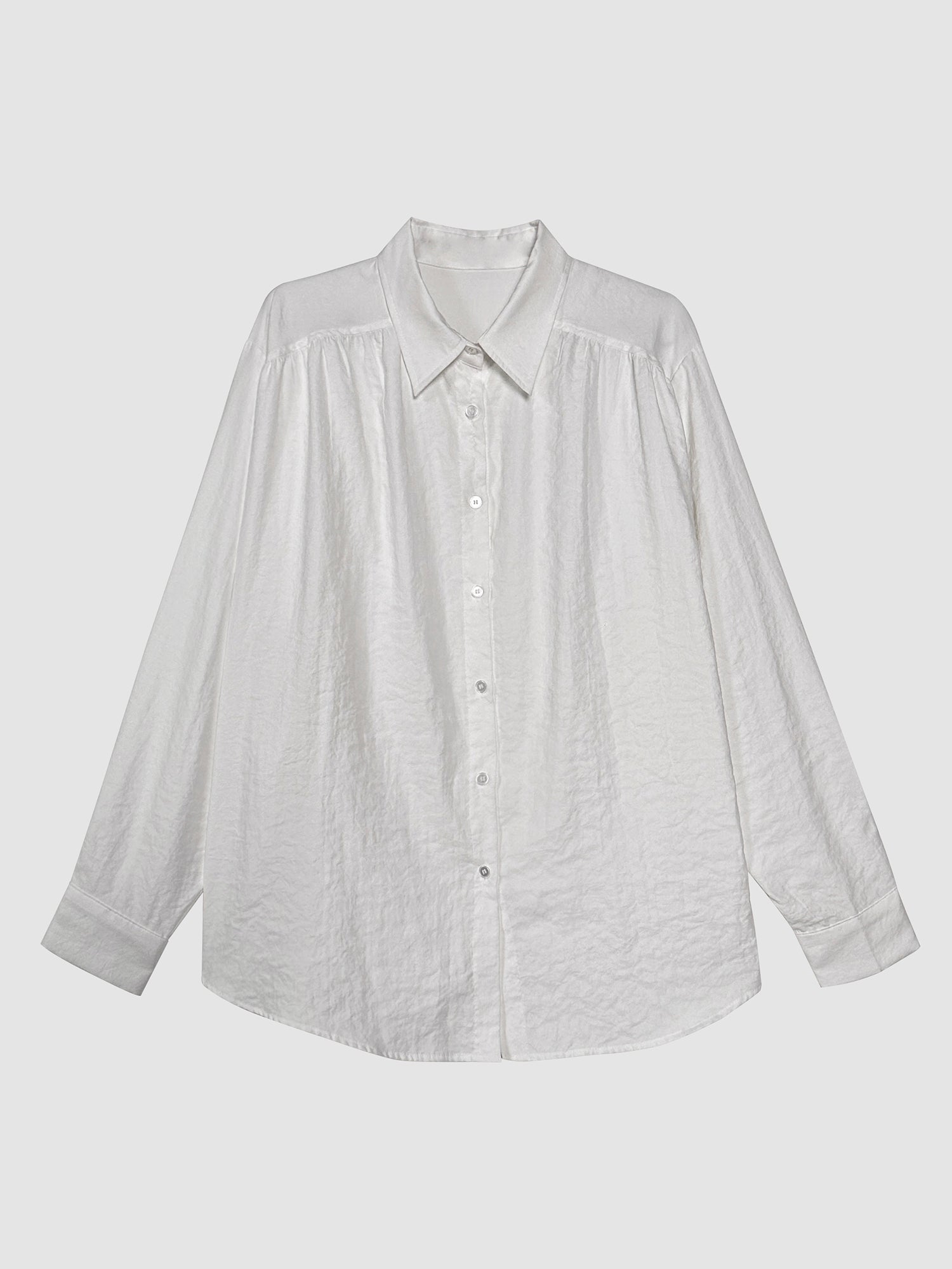 Product detailed view of the white relaxed classy shirt with white backdrop to show its front design of the shirt.