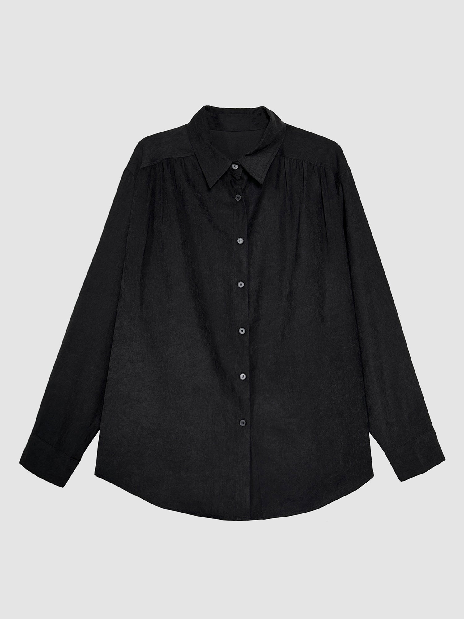 Product detailed view of the black relaxed classy shirt to showcase its intricate buttons and designs of the shirt.