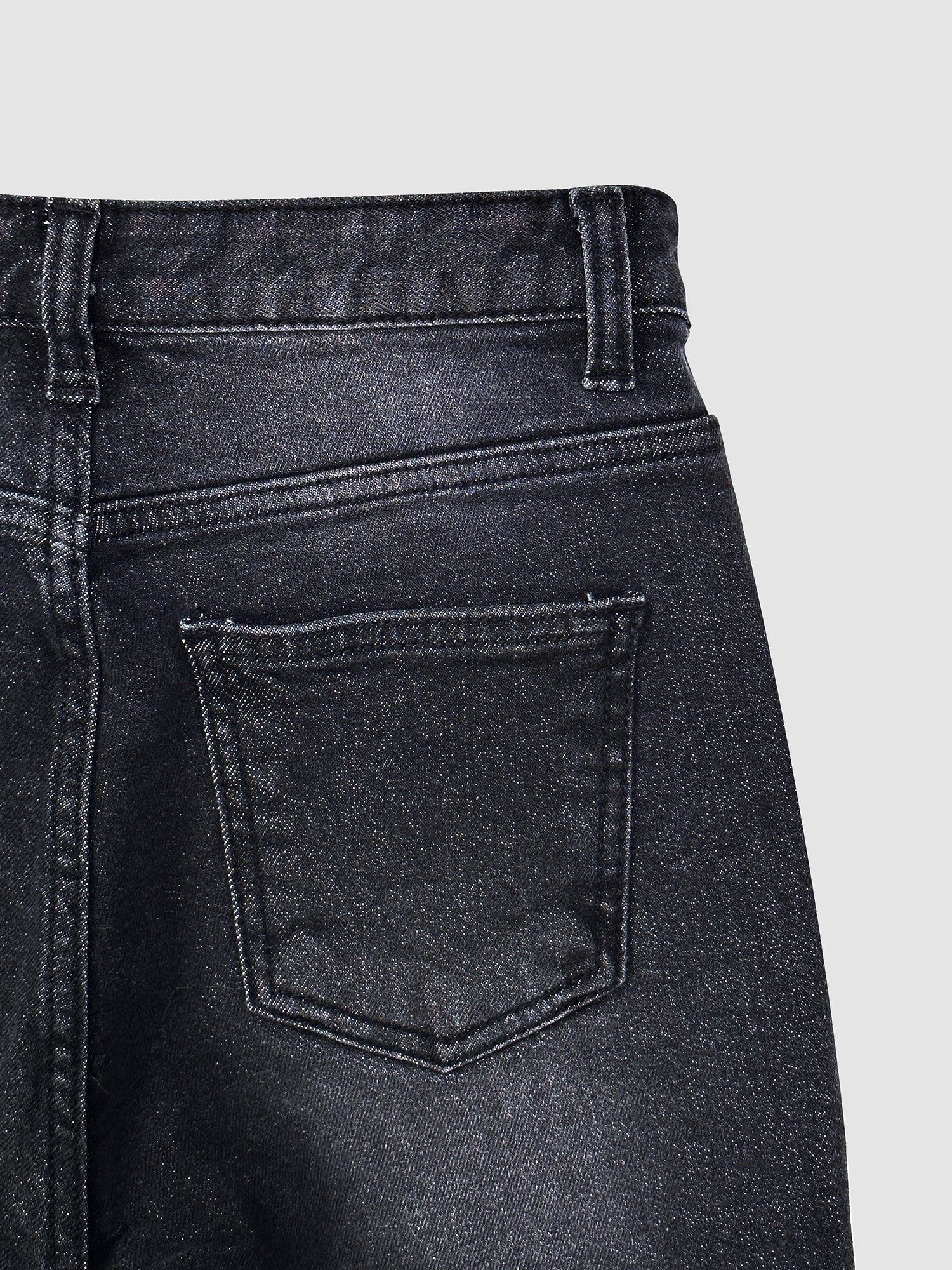 Zoomed-in view of the skinny flare jeans showing the back pocket details.