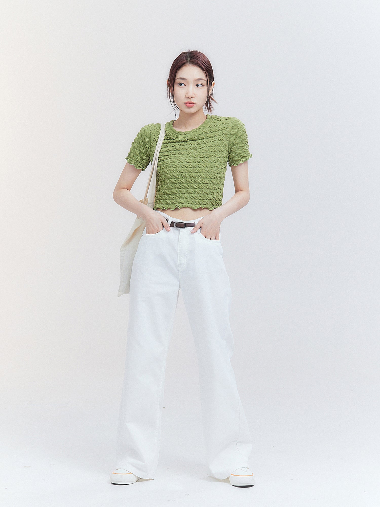 A full-shot of the model wearing the sage waffle textured top.