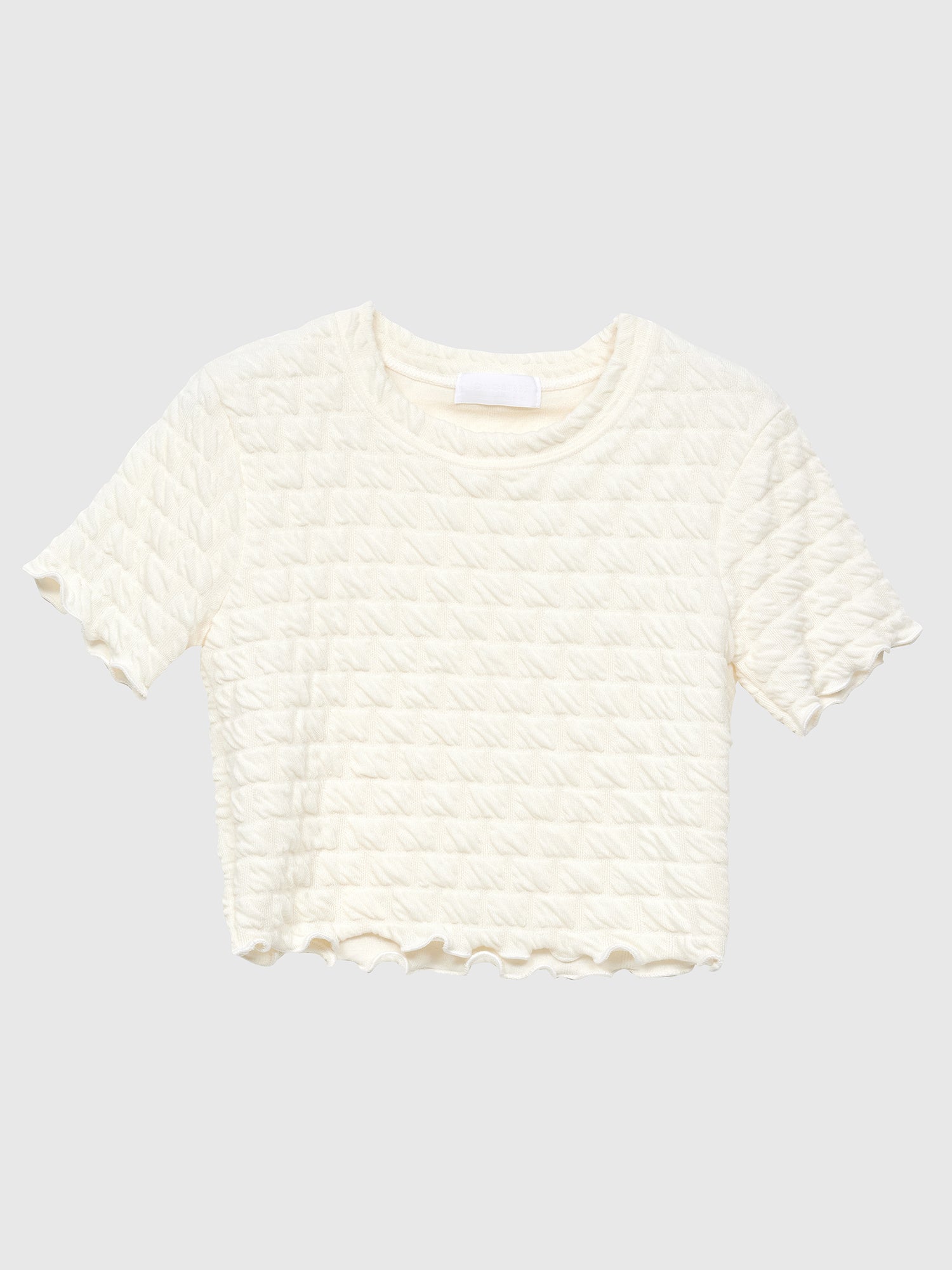 Front view of the ivory waffle textured top showing the intricate details of the pattern design.